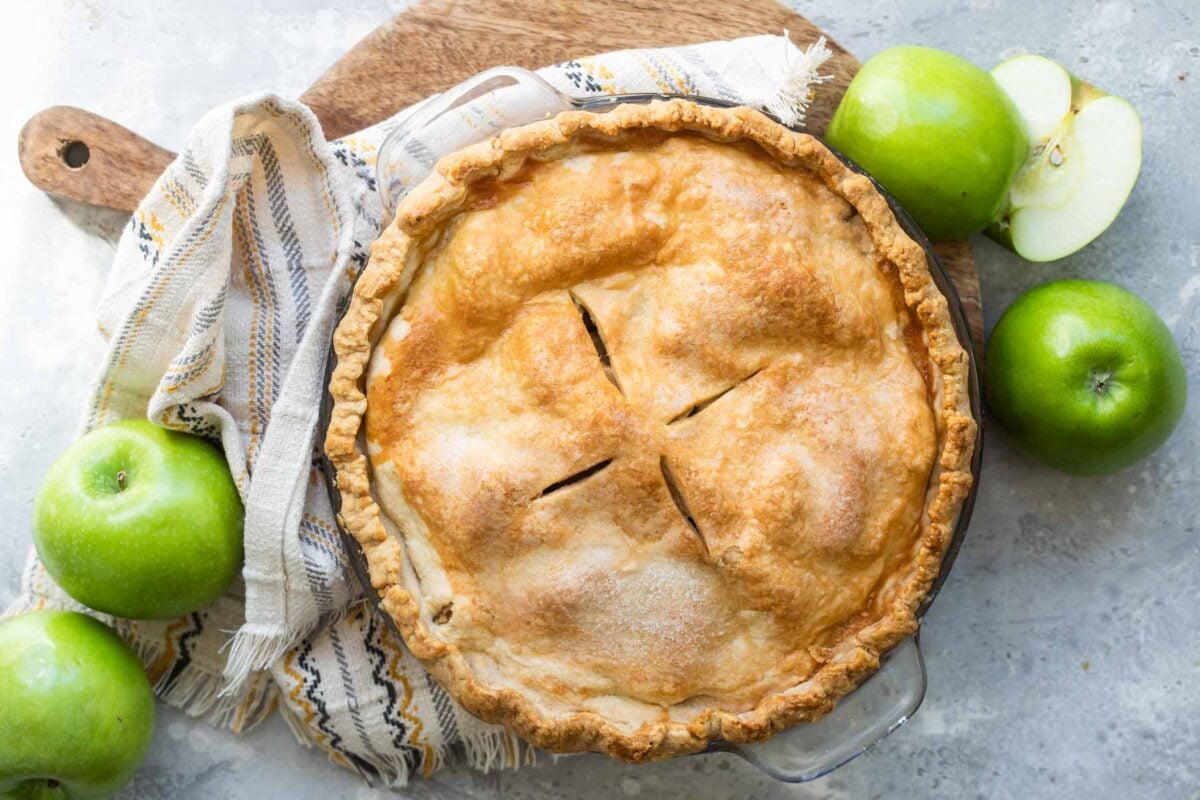 A baked, unsliced apple pie.