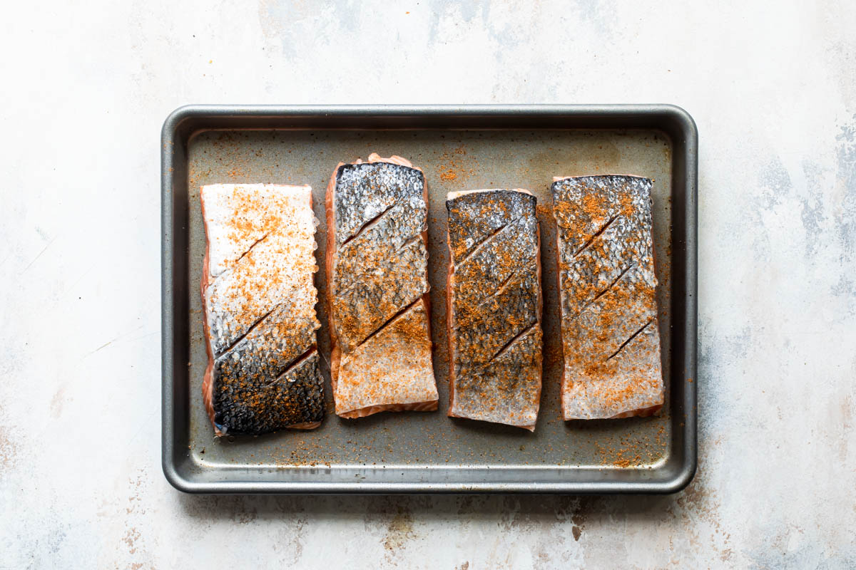 Raw salmon on a baking sheet.