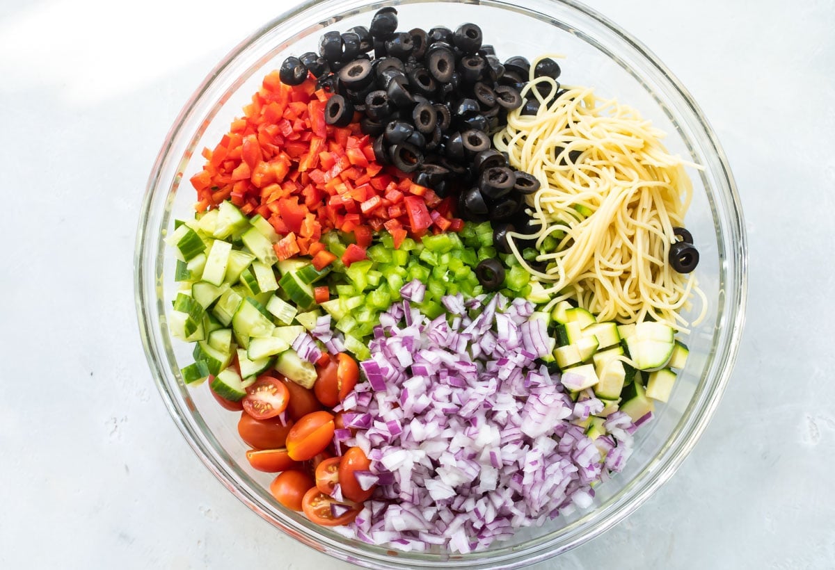 A bowl with California pasta salad ingredients.