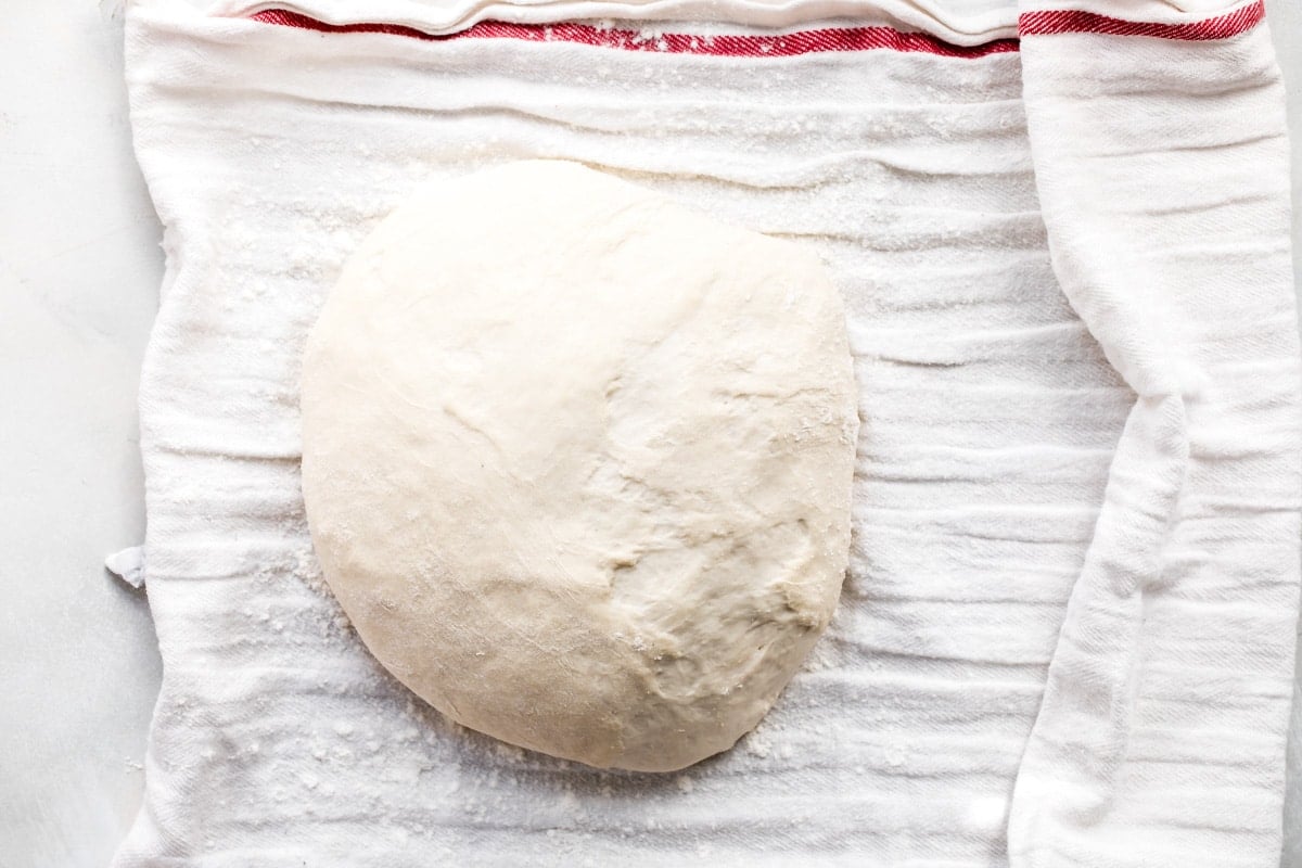 No knead bread dough on a kitchen towel.