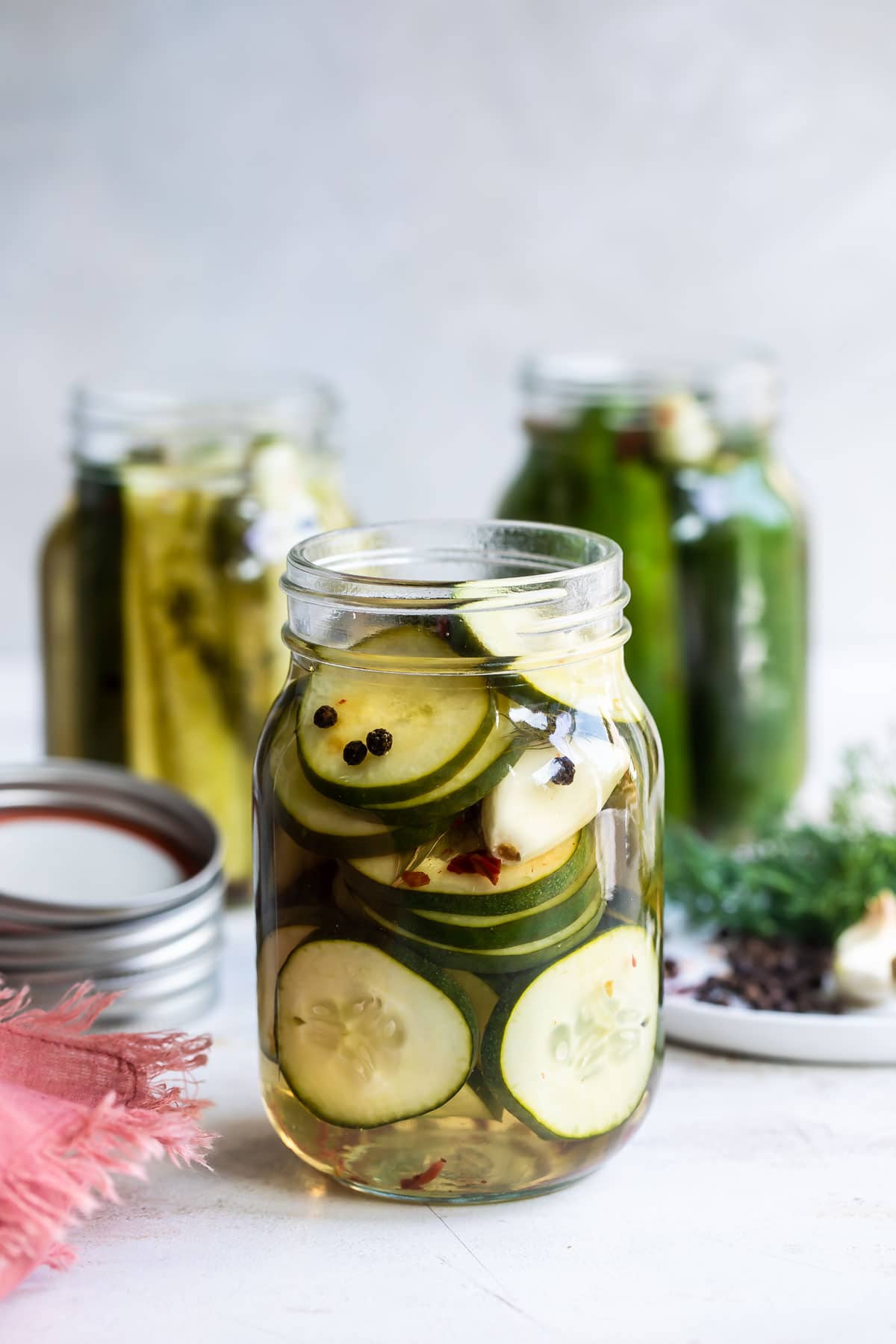 Three mason jars filled with pickles.