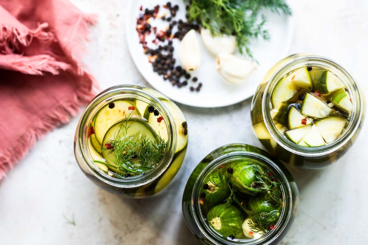 Mason jars with pickles in them.