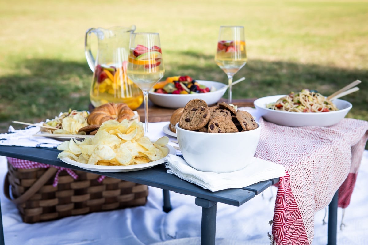 A set up of a picnic foods in a park.
