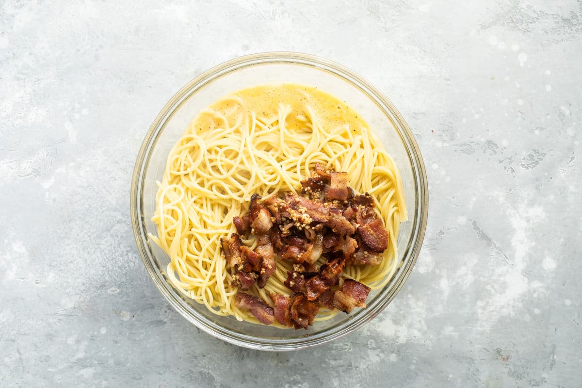 Spaghetti carbonara ingredients in a glass bowl.