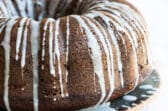 A round spice cake with drizzled icing.