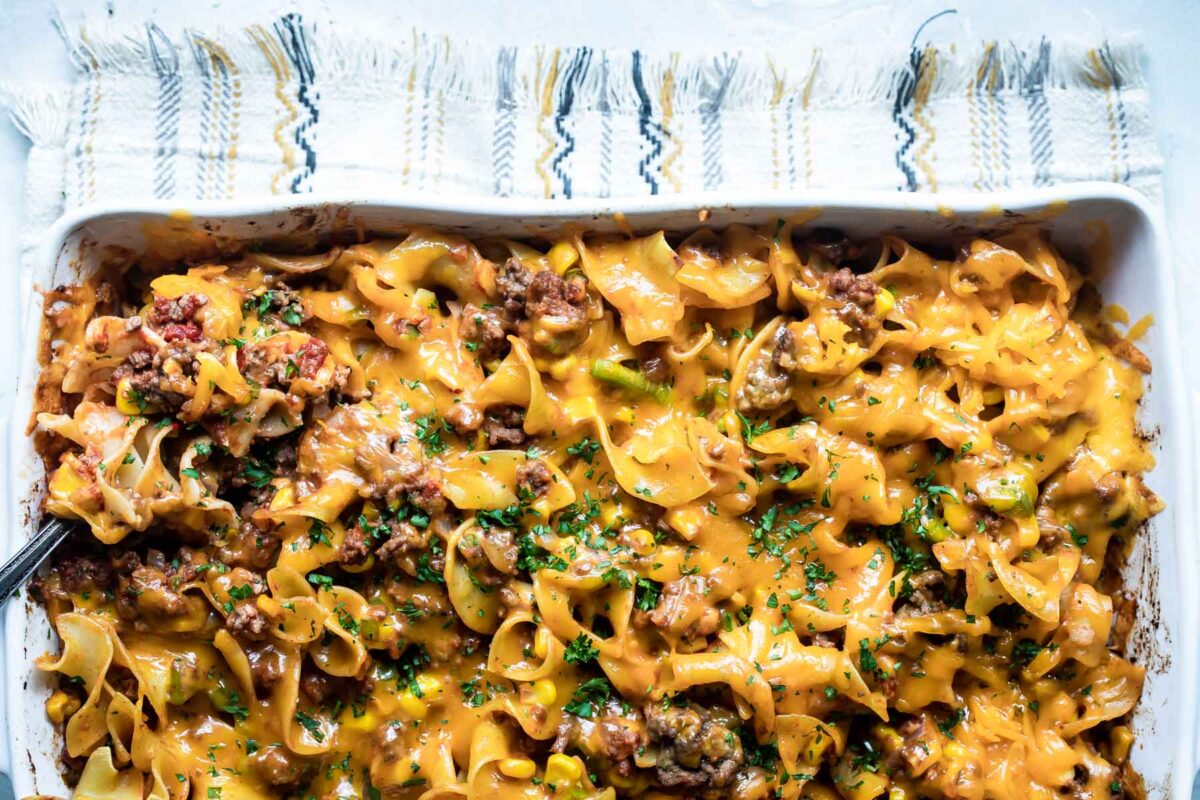 Beef noodle casserole in a white baking dish.