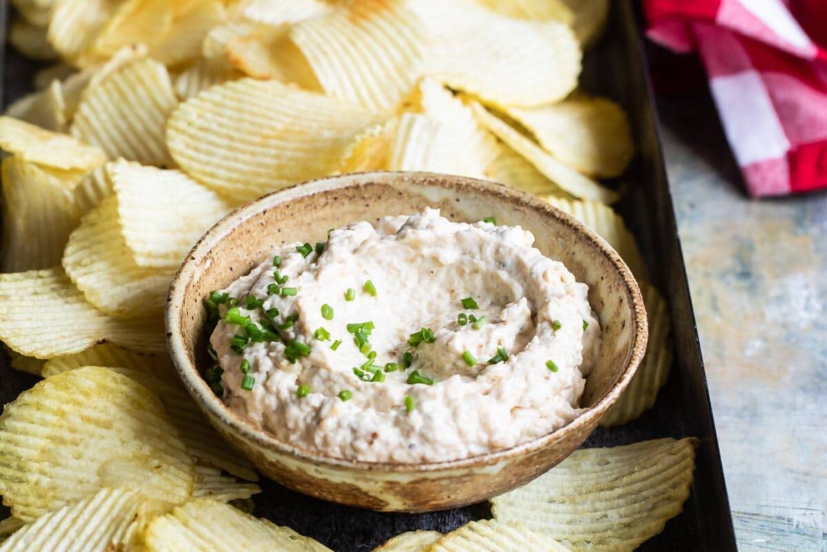 French onion dip and chips on a serving platter.