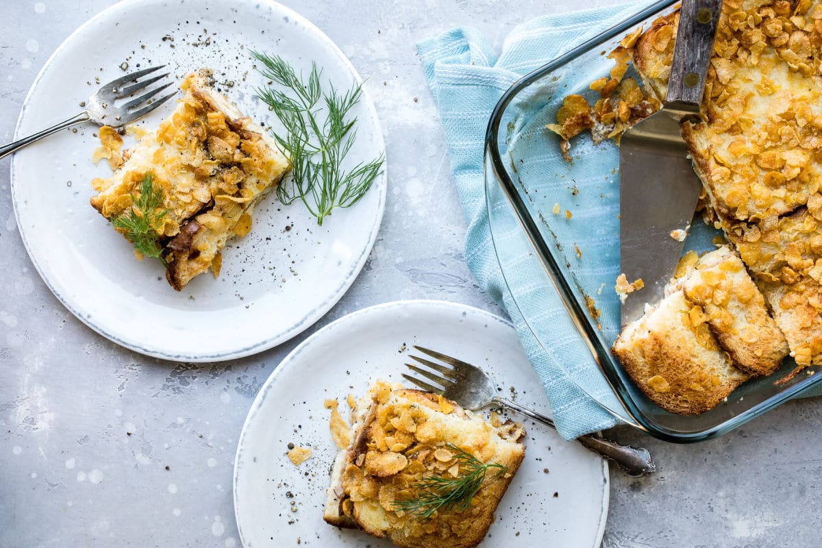 Overnight breakfast casserole on plates and in a glass baking dish.