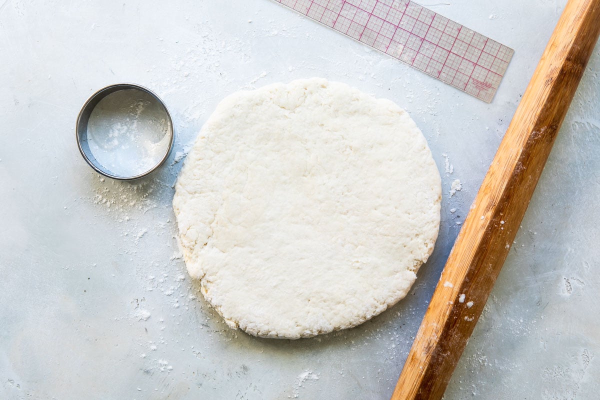 Biscuit dough patted in to a circle.
