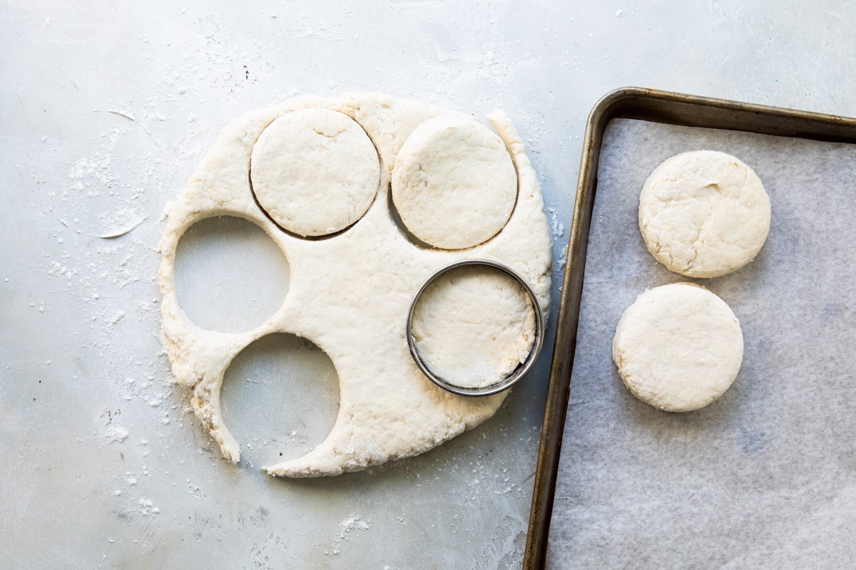 Cutting out biscuits from a round of dough.
