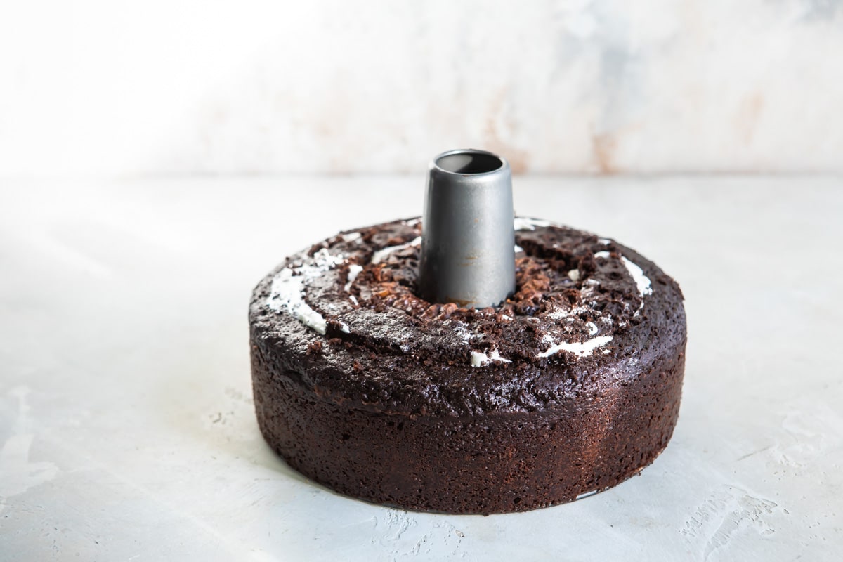 Chocolate cake with a metal tube in the middle.