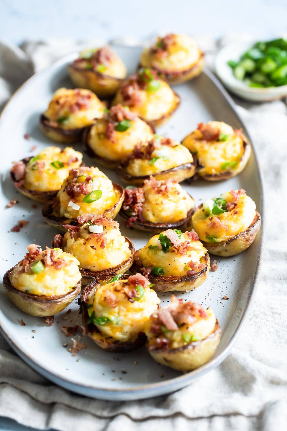 Mini twice baked potatoes on an oval serving platter.