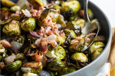 Roasted Brussels Sprouts with bacon in a gray dish.