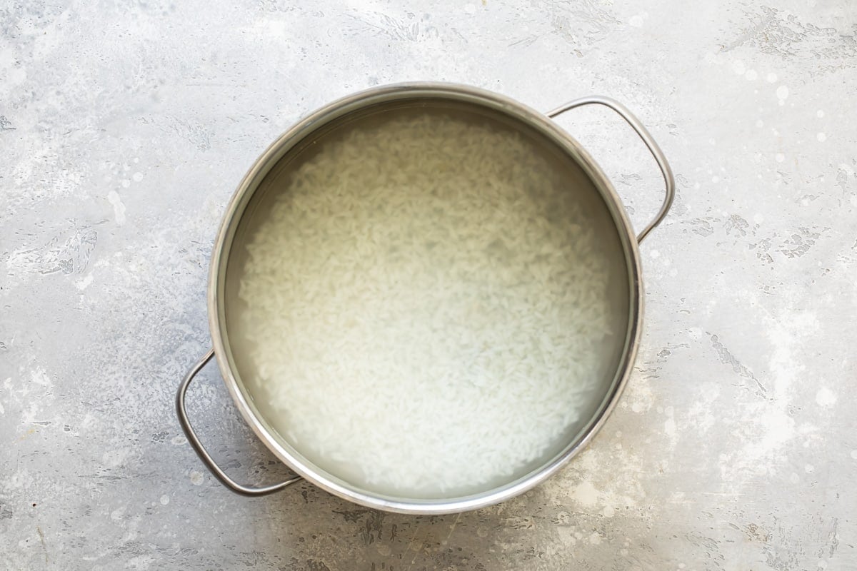 Rice cooking in a sliver pot.
