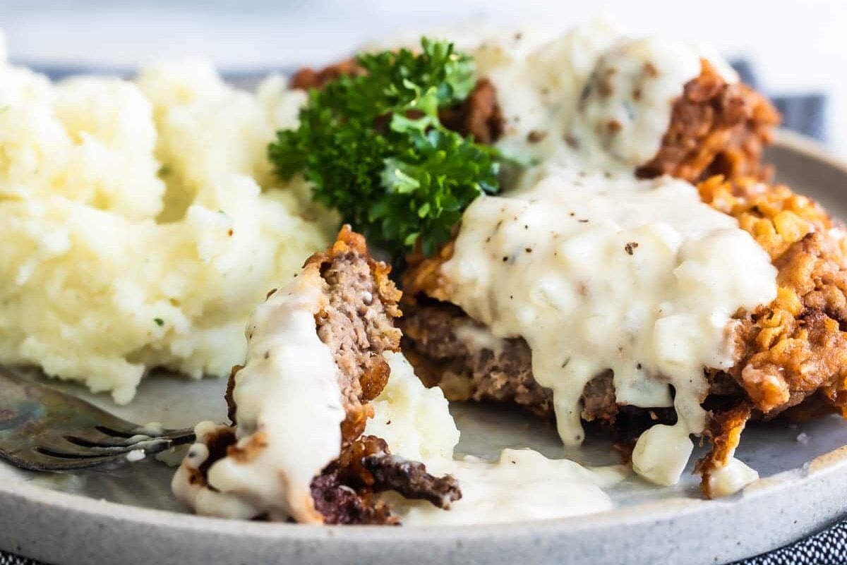 Country fried steak and mashed potatoes on a plate.