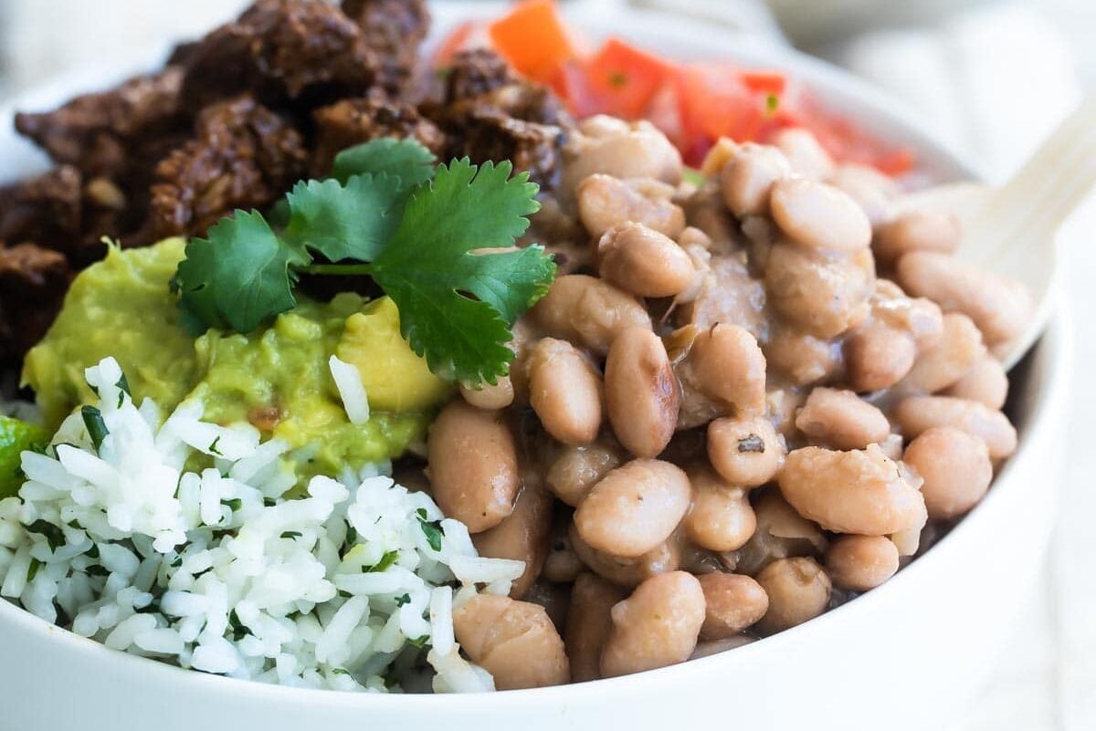 A bowl of Chipotle steak, pinto beans, cilantro-lime rice, and pico de gallo.
