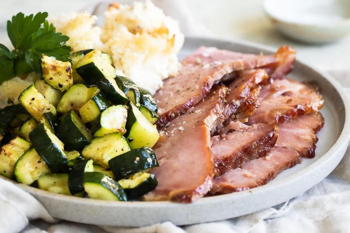 Dr. Pepper ham and vegetables on a plate.