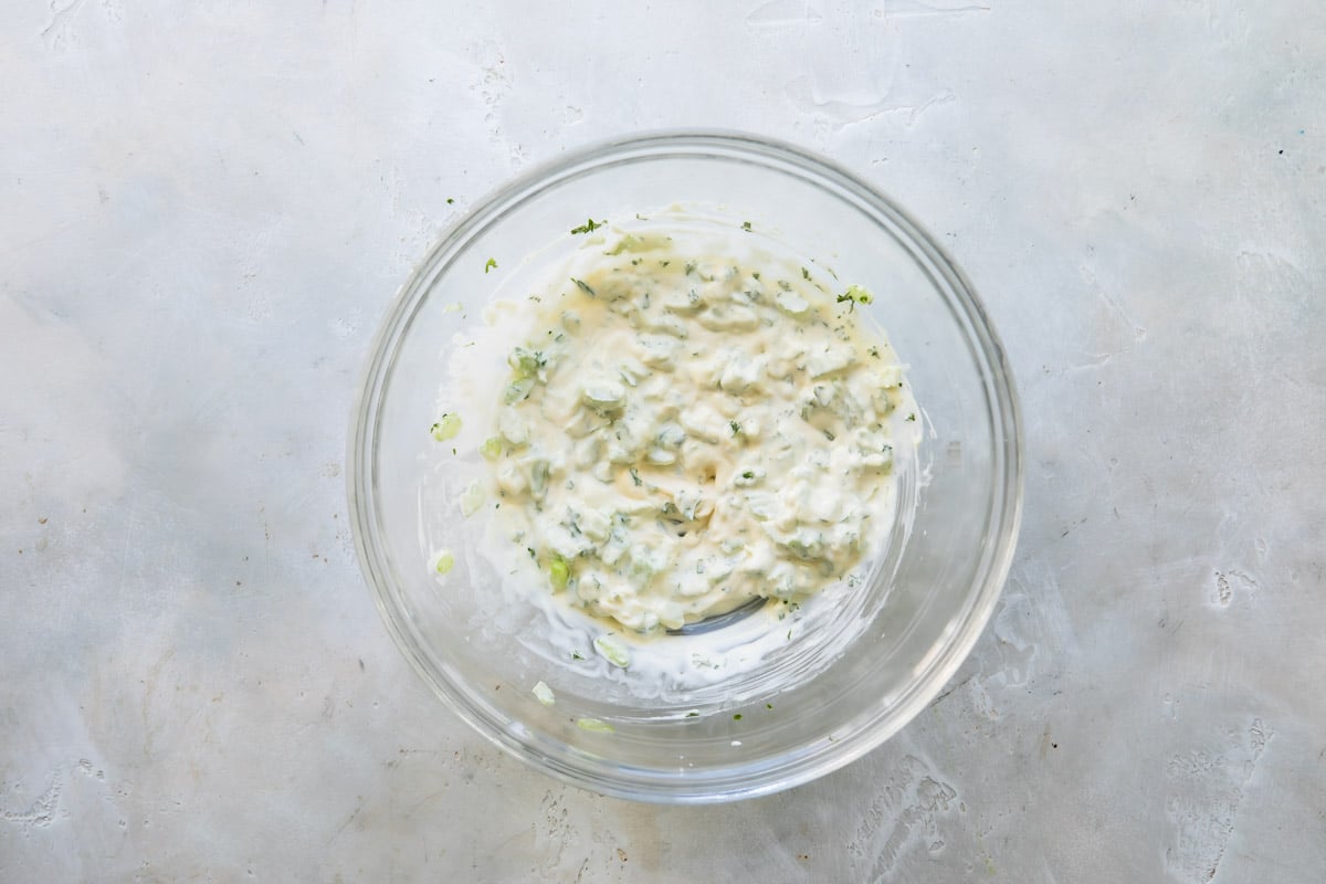 Egg salad mixture in a clear bowl.