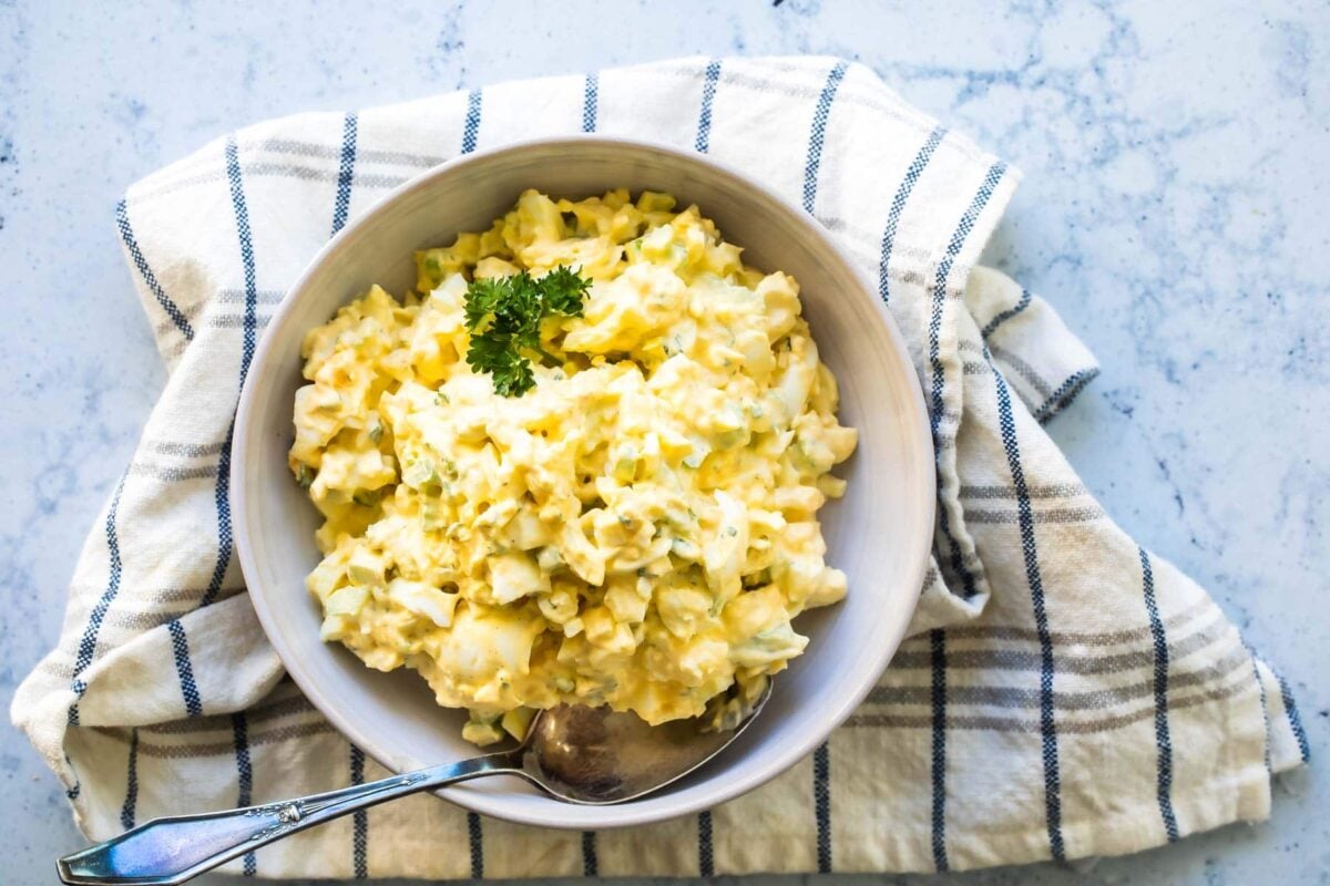 Egg salad in a white bowl.