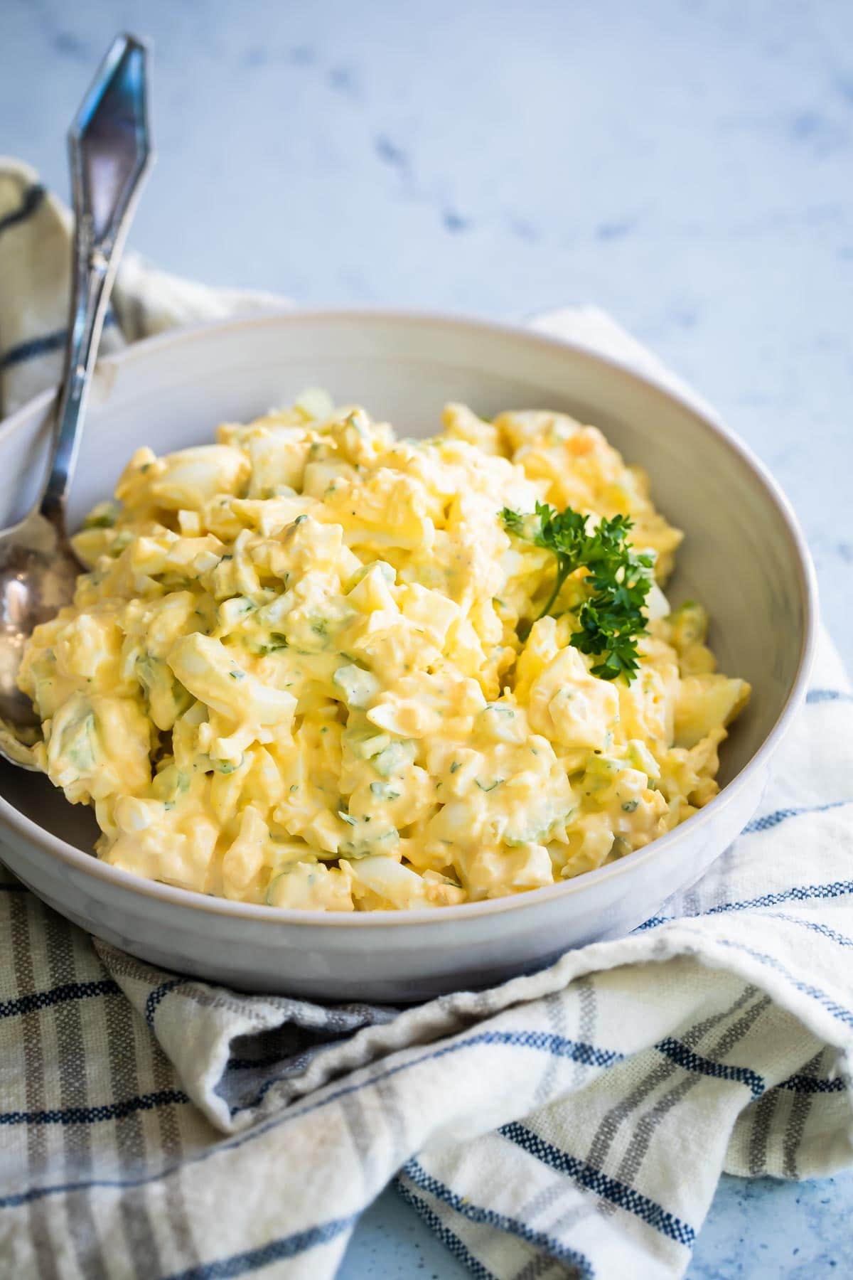 Egg salad in a white bowl.