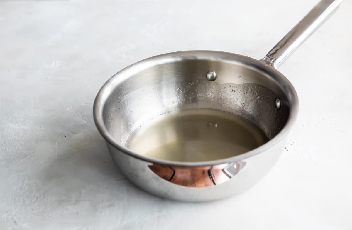A clear liquid in a saucepan.