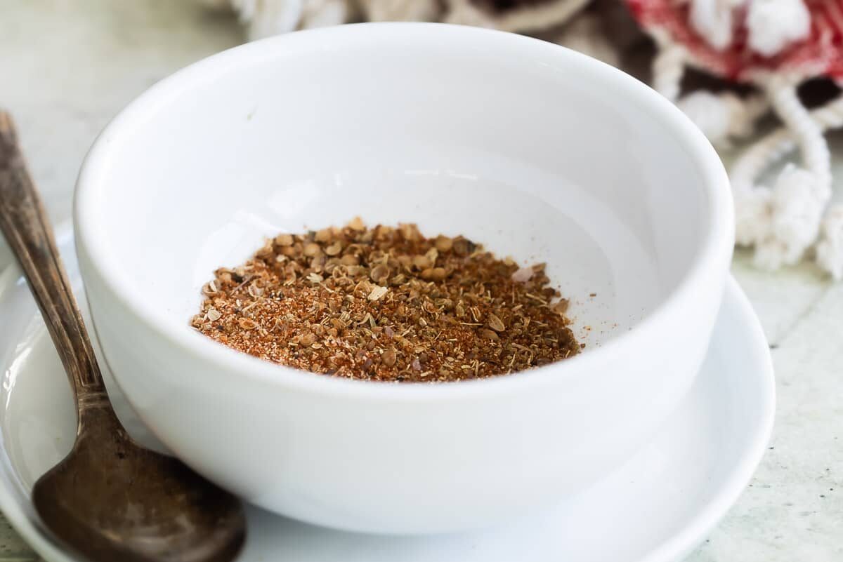 Pork spice blend in a small white bowl.