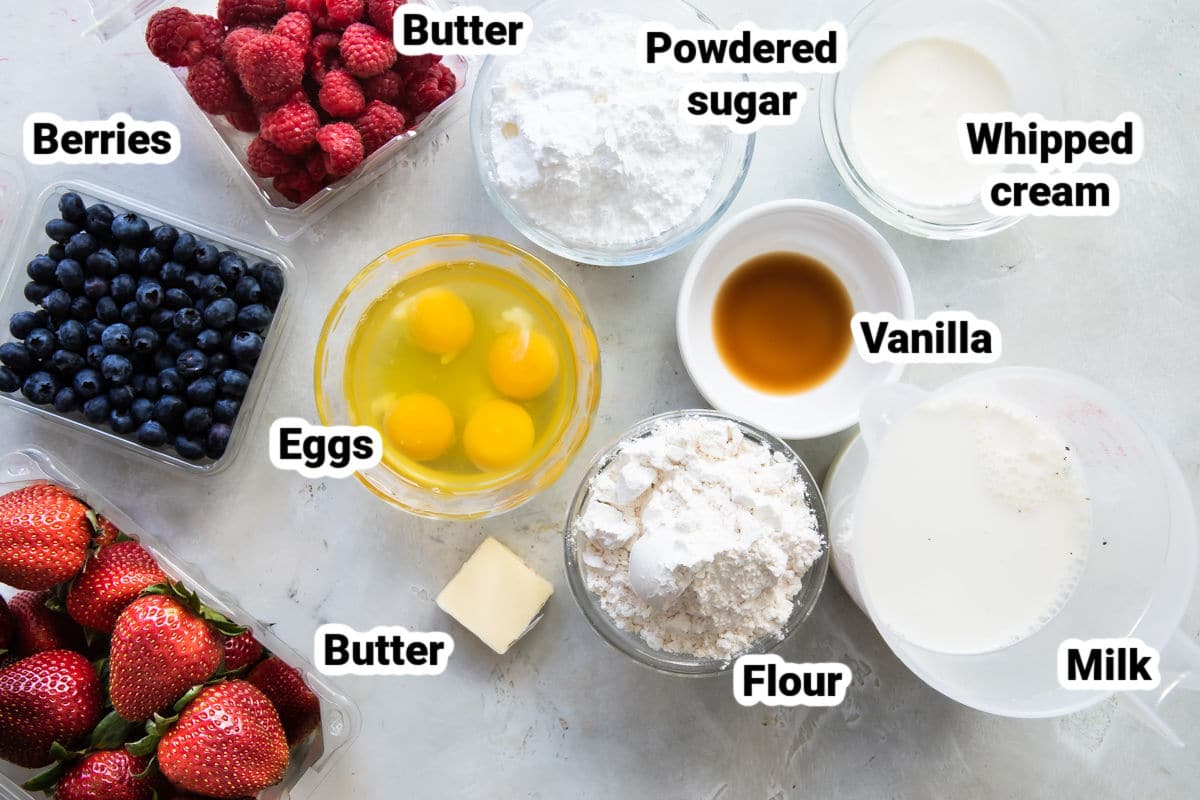 Ingredients for crepes in bowls and labeled.