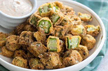 Fried okra pieces in a white bowl.