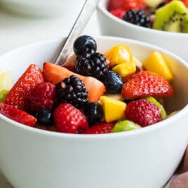 Fruit salad in a small white bowl.