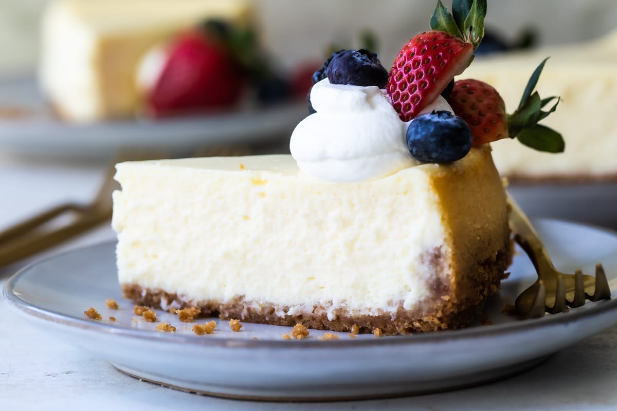 A slice of vanilla cheesecake on a plate.