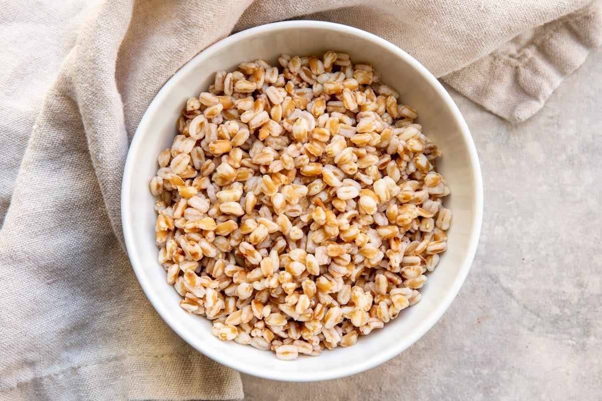 A white bowl with cooked farro in it.