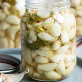 Pickled garlic in a mason jar.