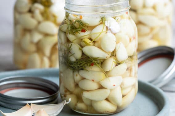 Pickled garlic in a mason jar.