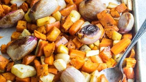 Roasted root vegetables on a baking sheet.
