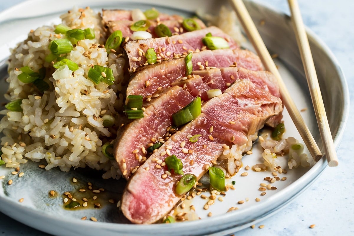 Ahi tuna on a plate with brown rice.