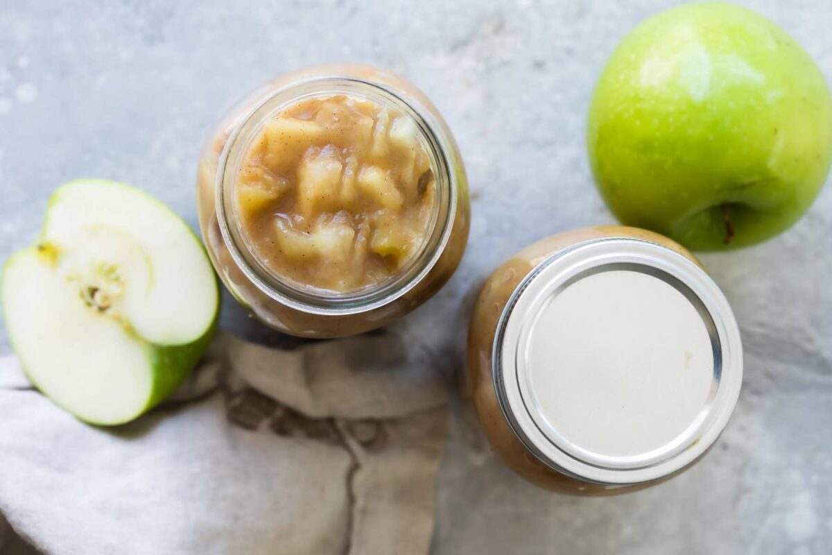 Two jars filled with apple pie filling.