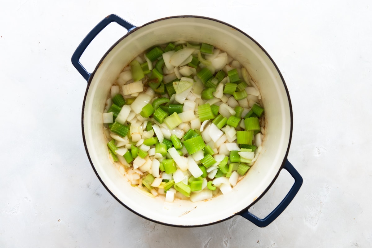 Celery and onion cooking in a Dutch oven.