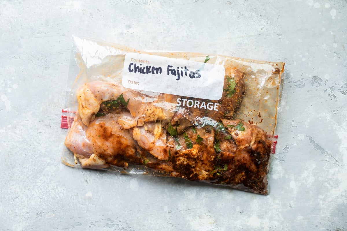 Chicken marinading in a Ziploc bag.