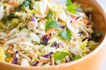 A bowl of Chinese chicken salad with Asian salad dressing.