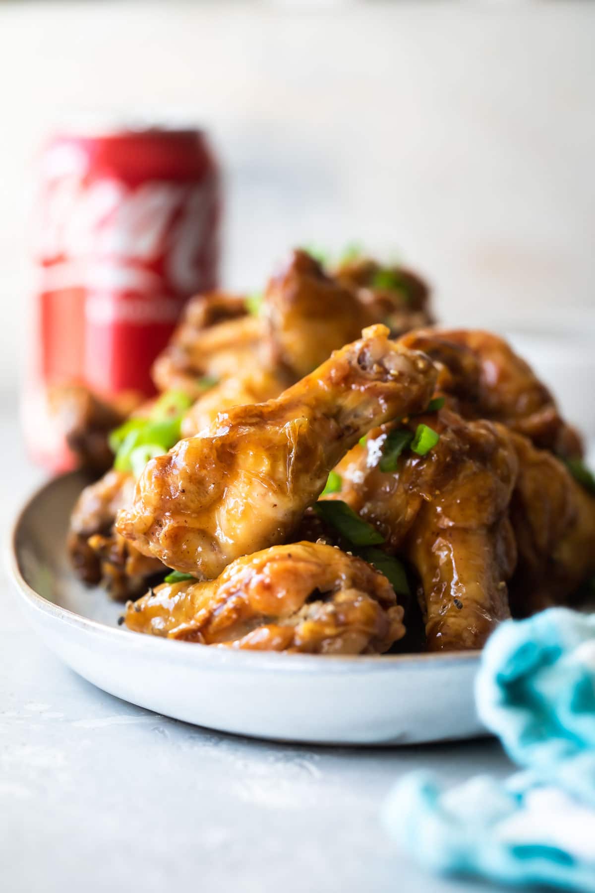 Coca Cola chicken wings on a white platter.