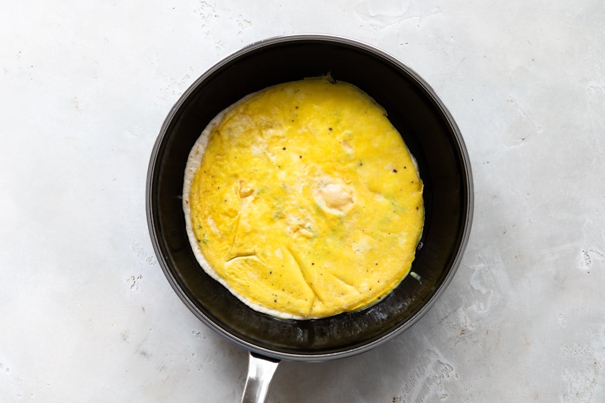 An egg burrito in a frying pan.