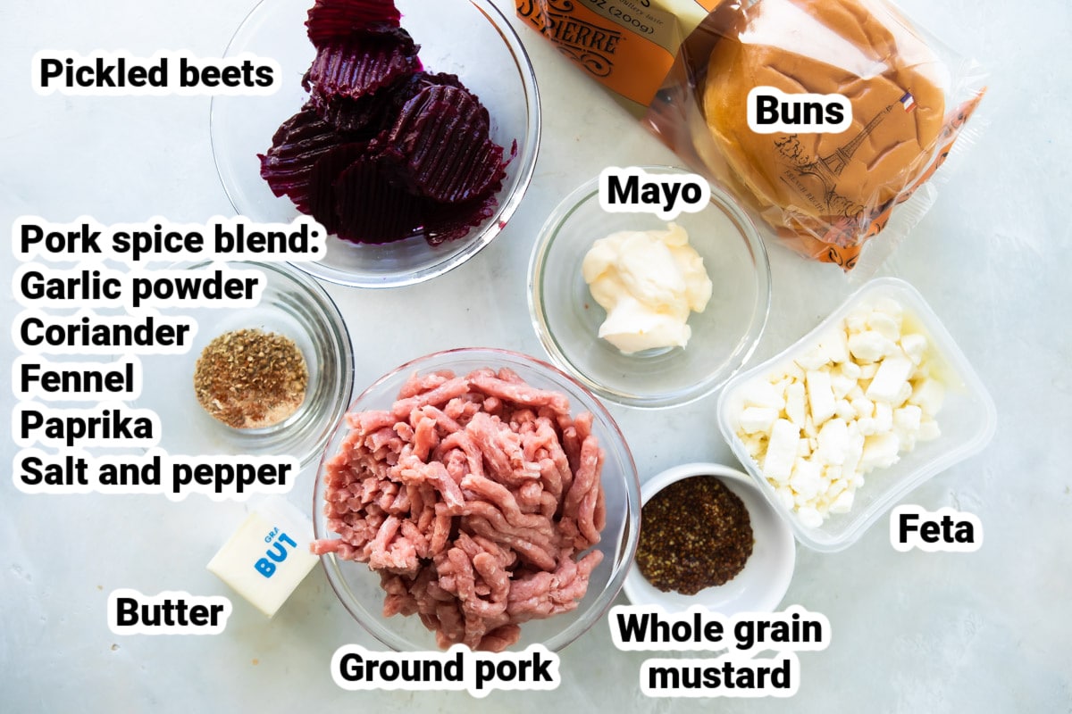 Labeled ingredients for pork burgers with feta mustard.