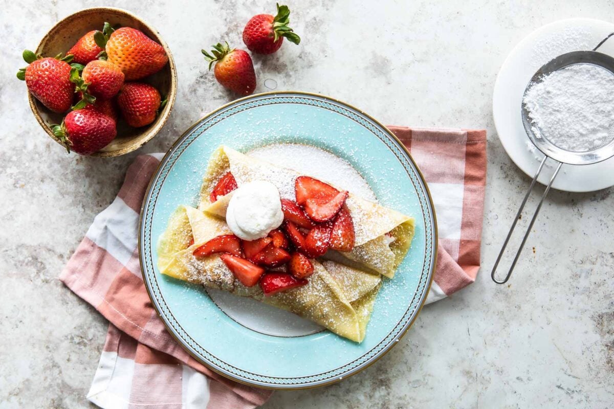 Strawberry crepes on a plate.