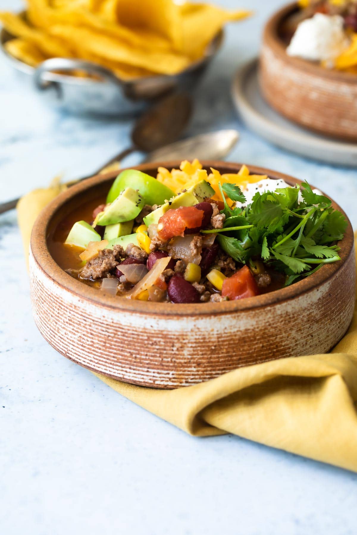 A brown bowl with taco soup.