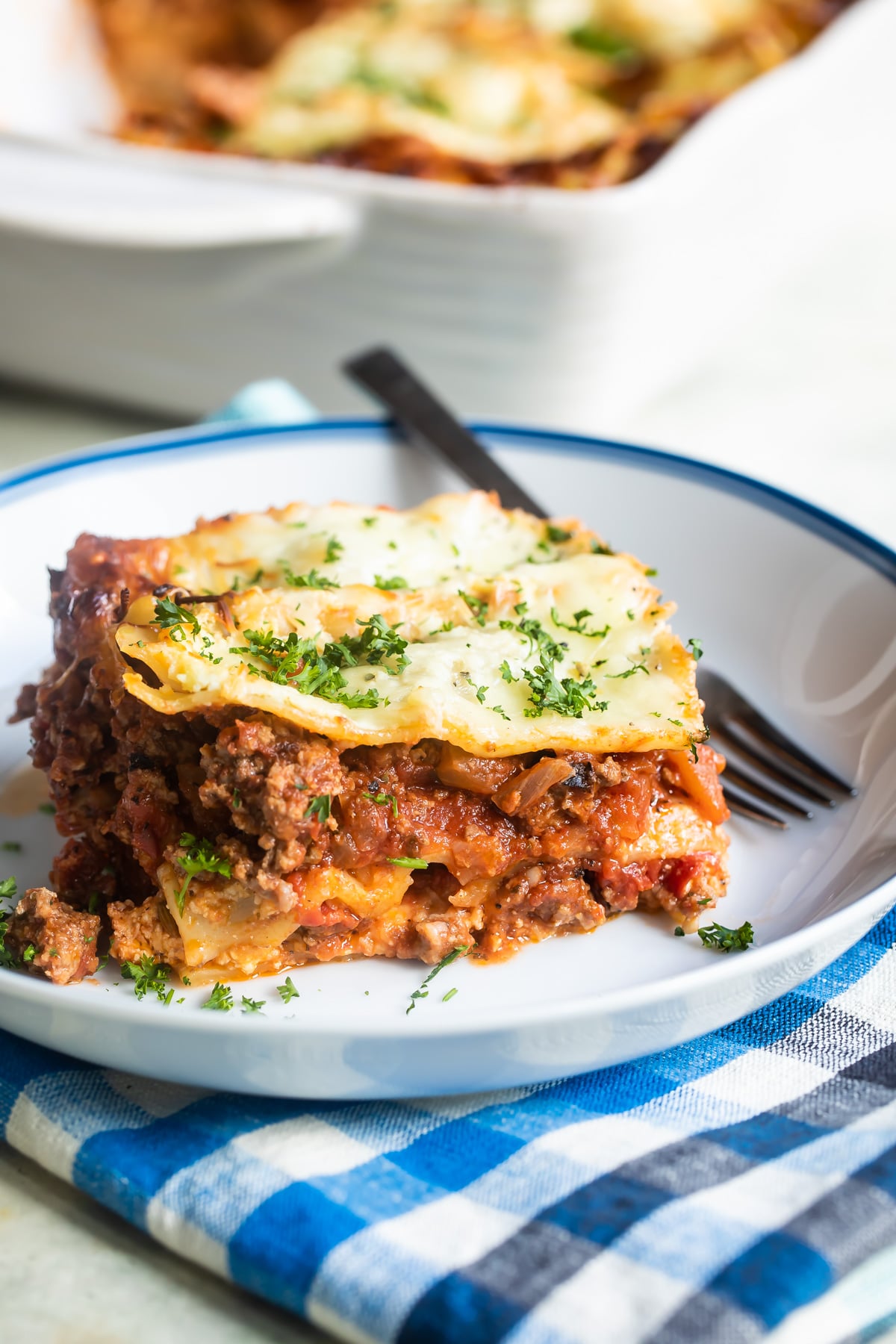 The best make ahead lasagna slice on a white plate.
