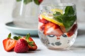 Glasses of water infused with fruit, vegetables, and fresh herbs.