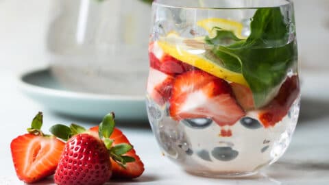 Glasses of water infused with fruit, vegetables, and fresh herbs.