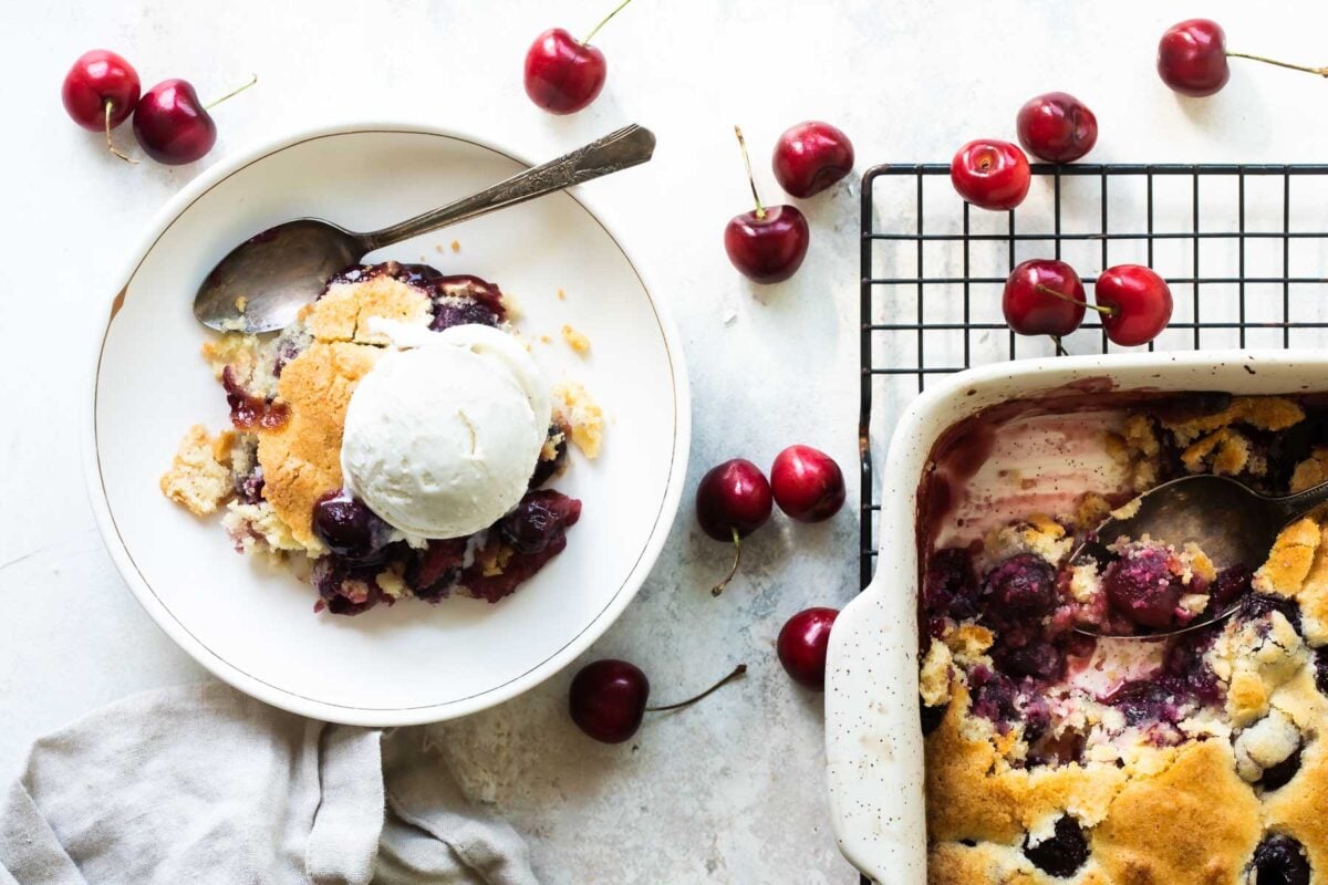 Two plates of blueberry cobbler with ice cream.