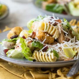 Chicken Caesar pasta salad on a gray plate.