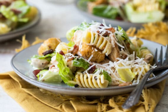 Chicken Caesar pasta salad on a gray plate.